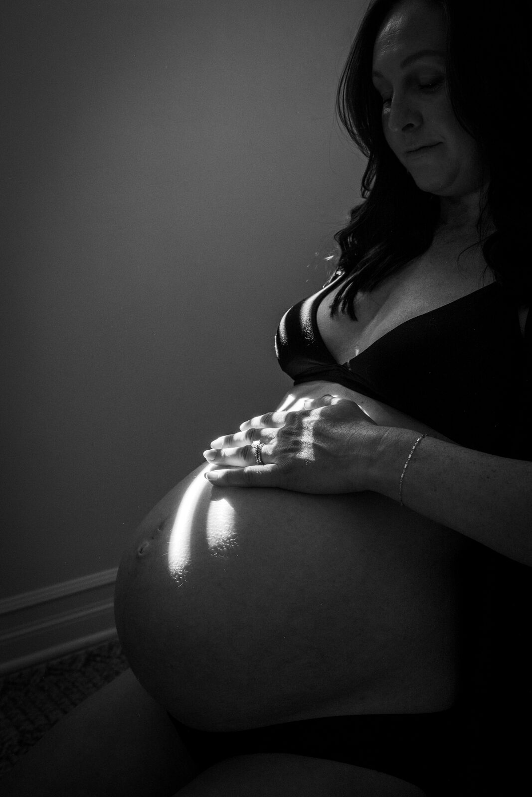 A hand and ring resting on the belly